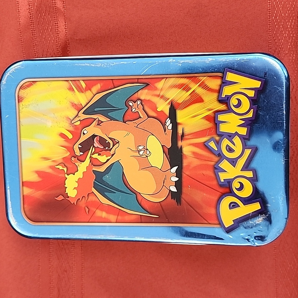 Pokémon charzard tv edition tin with 7 instruction manuals and 4 rule books